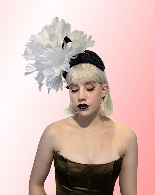 White Feather Flower Fascinator on black glass